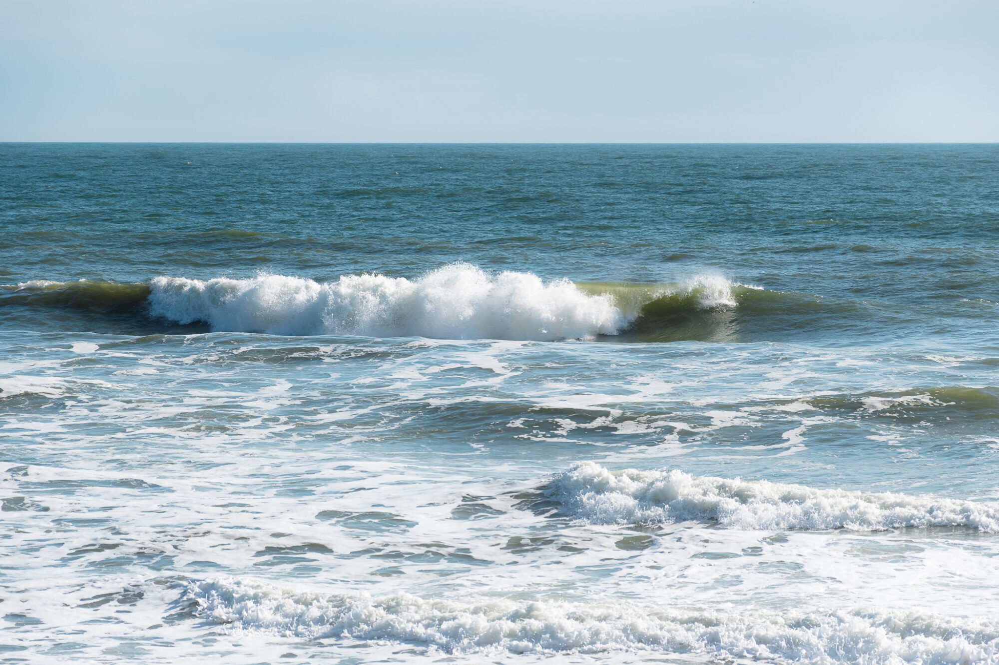 Morning at the beach on the Atlantic Ocean, waves crashing on the shore.